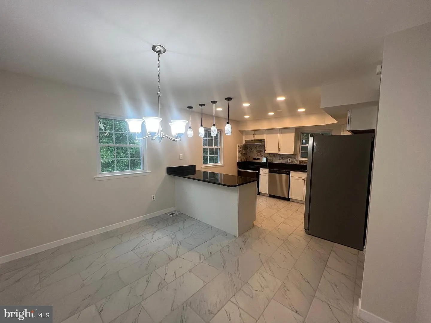 Welcome home to this beautifully updated end unit residence that combines modern finishes with sp... — Photo 3