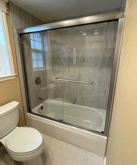 New remodeled hallway full bathroom tub and glass door