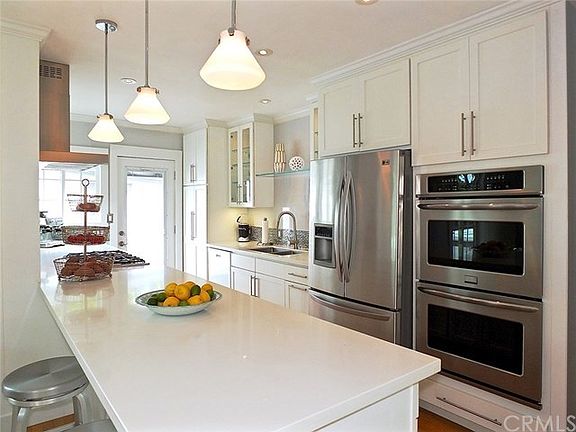 Kitchen with quartz counters, double ovens and custom soft close drawers