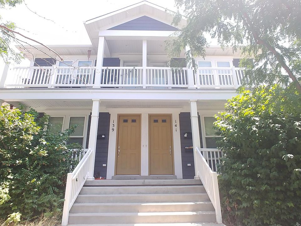 Front entry of the building showing the deck off the master bedroom