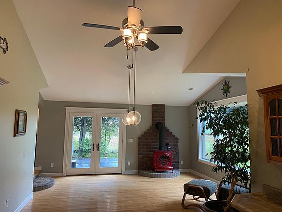 Dining room with french doors opening to back concrete patio. Dining room windows/doors offer best views of evening sunsets over ridge line.