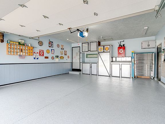 Garage Workshop Check out this Amazing Finished Garage with Epoxy Flooring, Storage and Service Door