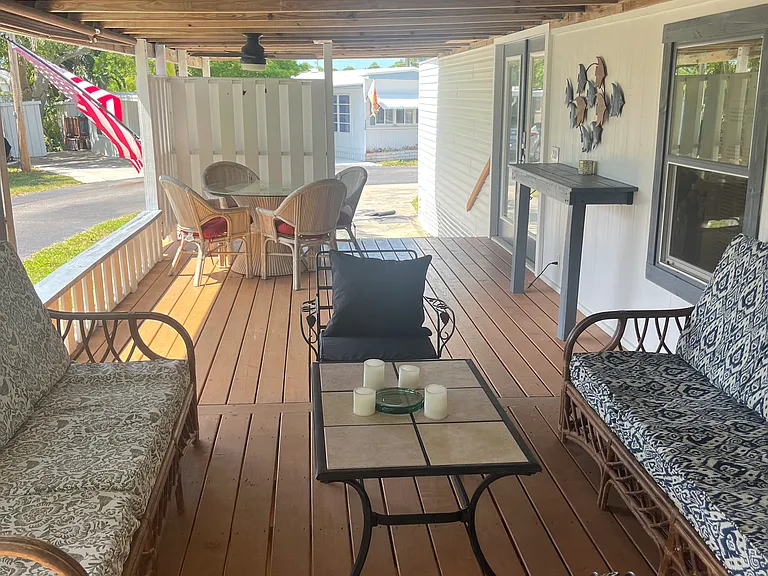 A look from the outdoor shower back toward the dining table and driveway beyond.