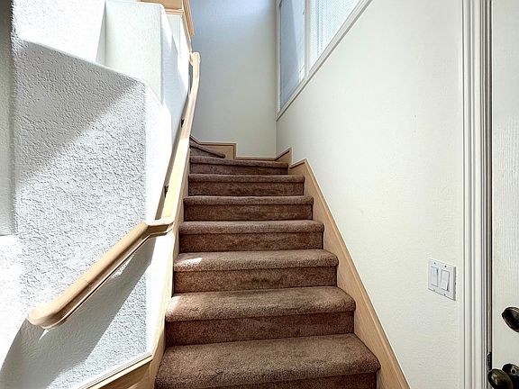Stairway to the single-story, upper-level condo.
