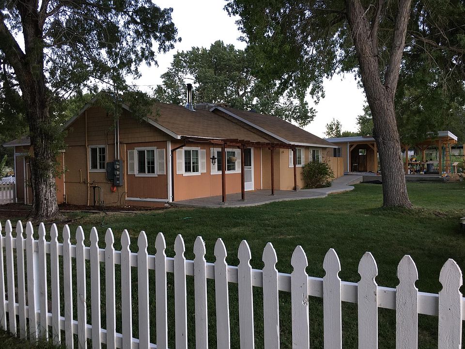 Front House with new walkway to the Carport with a ramp that is wheelchair accessible.