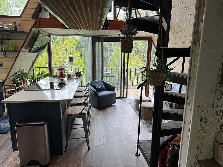 View of the spiral staircase to the loft and out to the balcony