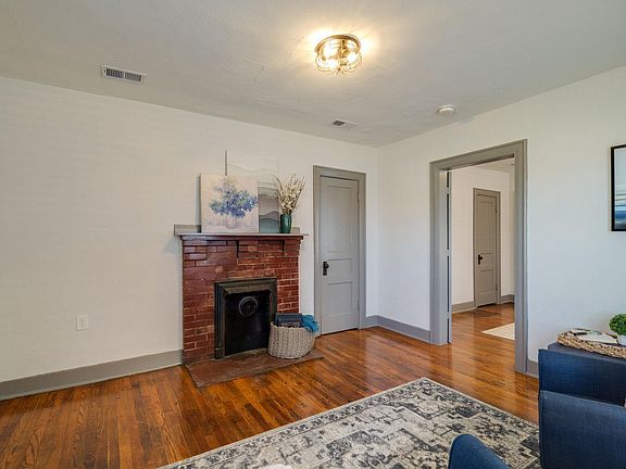 The living room features a fireplace, a coat closet, and access to the bedroom.