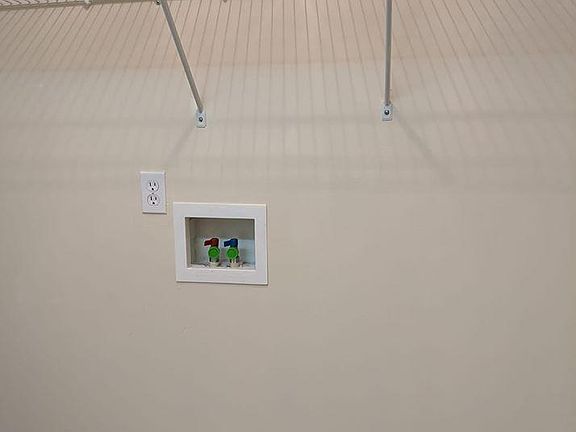 Note the good sized laundry area with convenient shelving to store your laundry supplies.