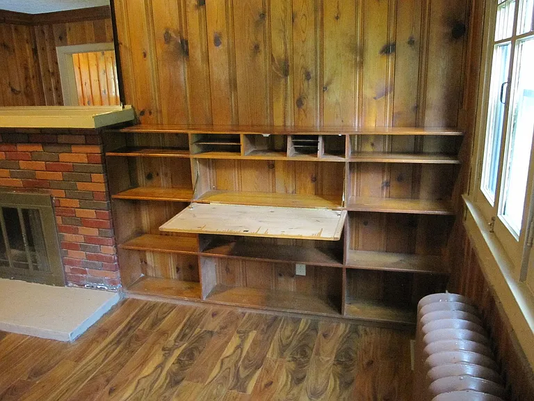 Living Room with built-in desk & bookcase. Note that radiators are for show only and are not functional.