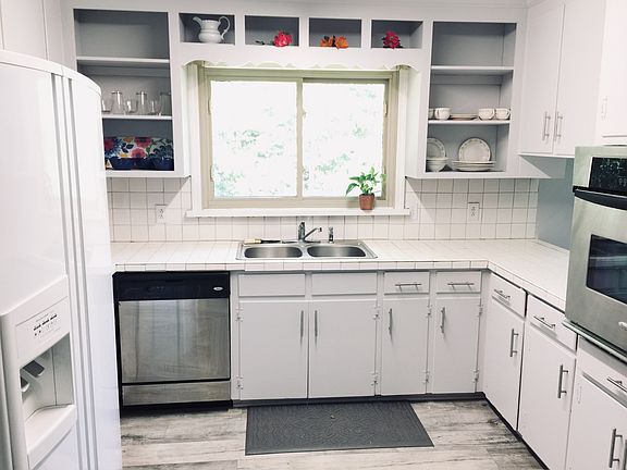 Kitchen overlooks leafy yard