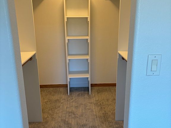 Primary bedroom walk-in closet