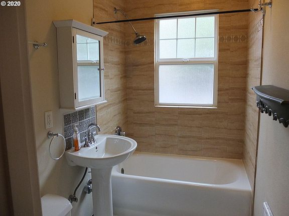 bathroom with original tiled flooring and newly refurbished tub