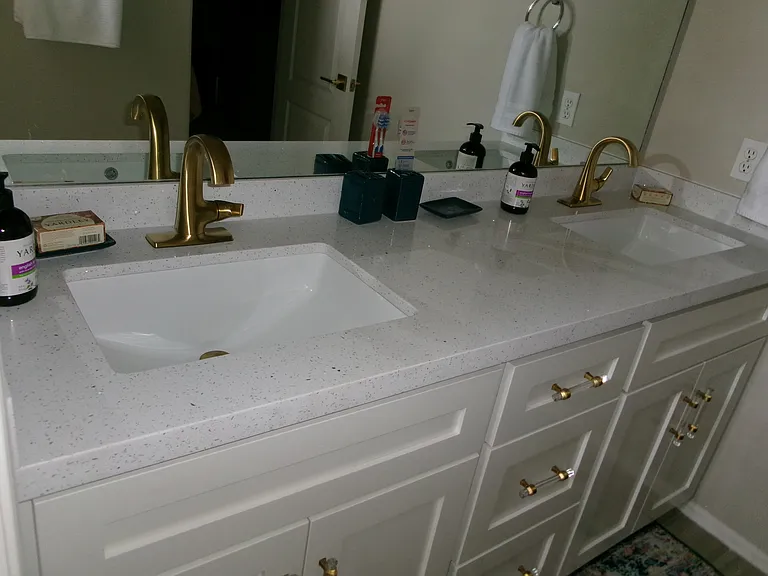 New vanity, new sinks, new faucets, new quartz counters.