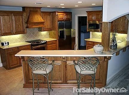 KITCHEN : CUSTOM CABINETS with 42" HI BAR SEATING AREA.