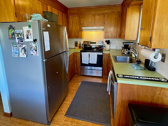 Midcentury kitchen with original cupboards and modern appliances and fixtures.