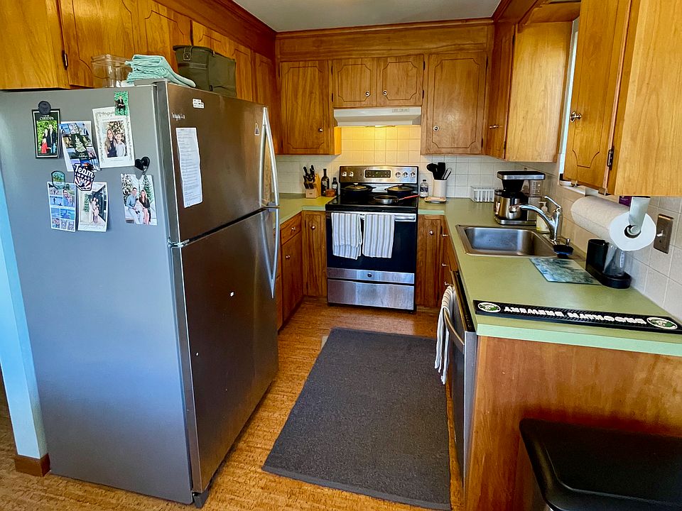 Midcentury kitchen with original cupboards and modern appliances and fixtures.