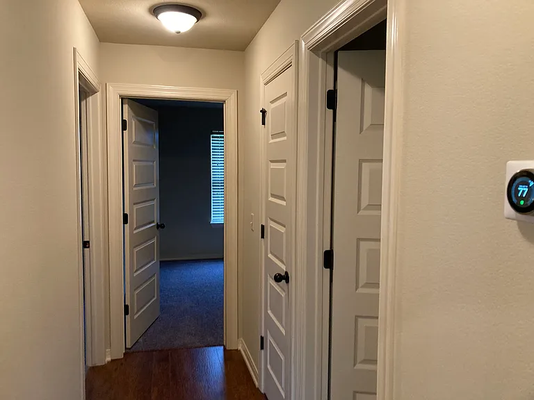 Hallway on other side of house/living room. Connects bedrooms 2-4, 2nd bath, and linen closet.