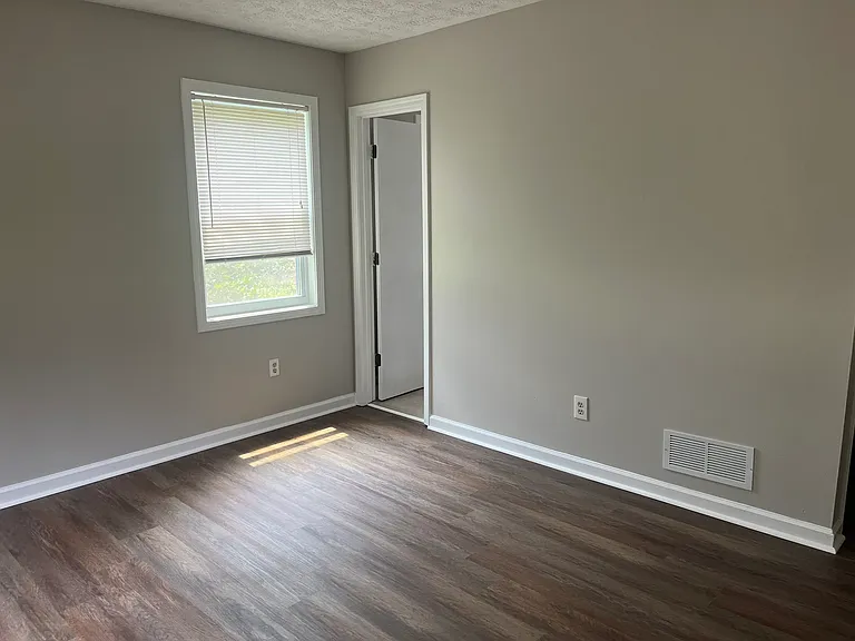Door to bathroom. All walls have been painted as well as ceilings.