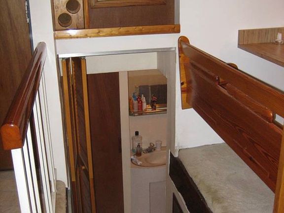 Viewing Bathroom from living room with Bifold door. Note wine rack.