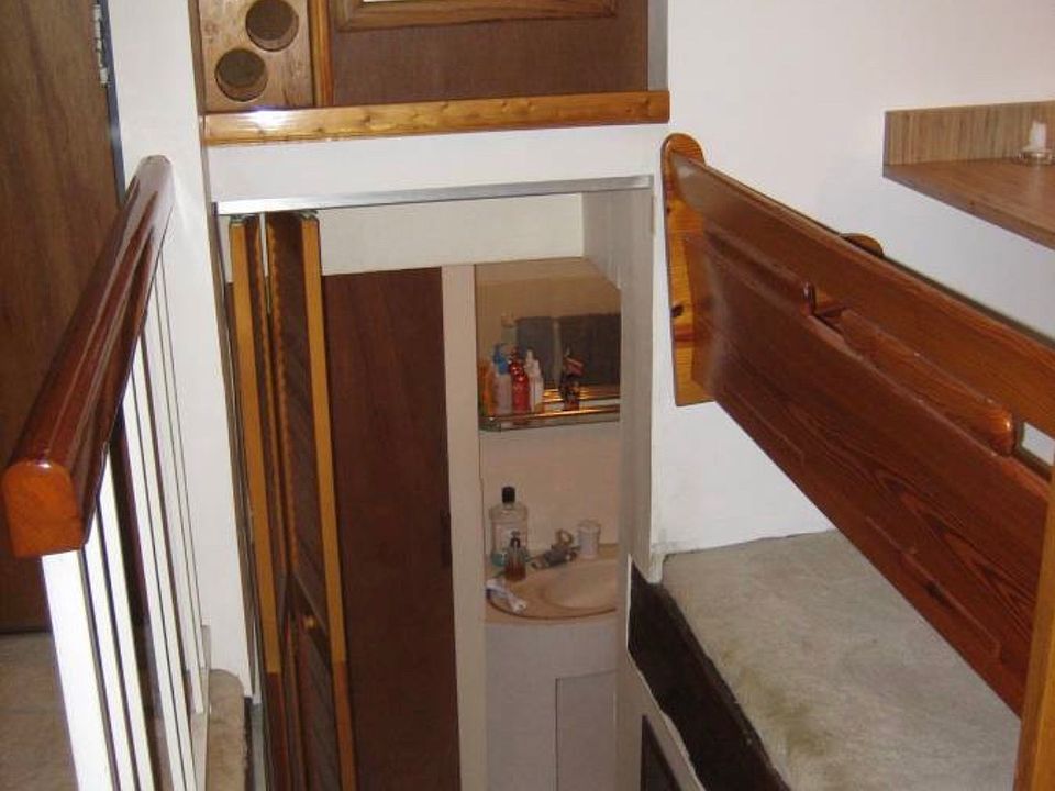 Viewing Bathroom from living room with Bifold door. Note wine rack.
