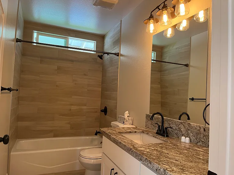 Shared guest bathroom with tub and shower