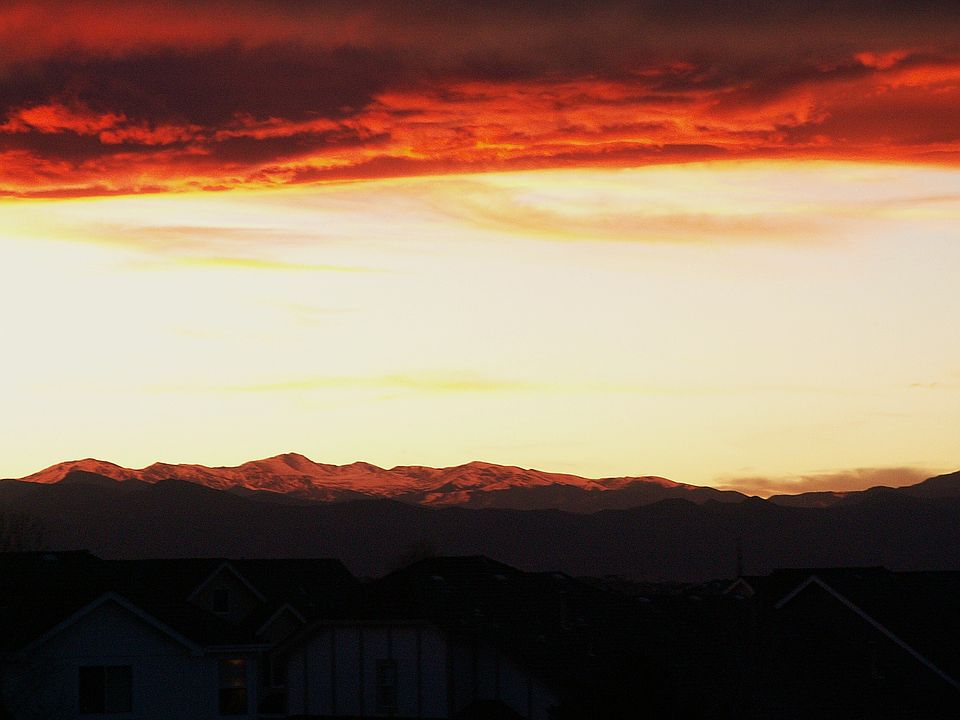 The glow of the Sunset lights up Mt Evans snow