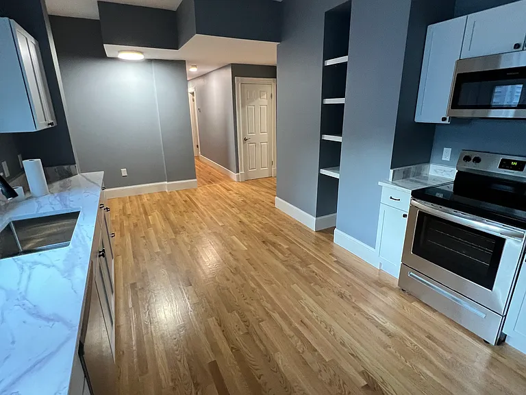 Eat-in kitchen with granite countertops and stainless steel appliances.