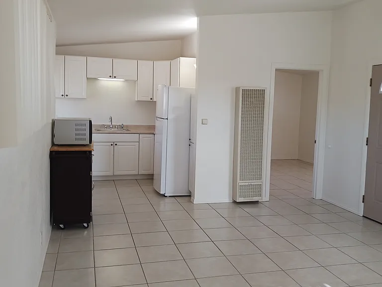 LIVING AREA LOOKING TO KITCHEN & BEDROOM