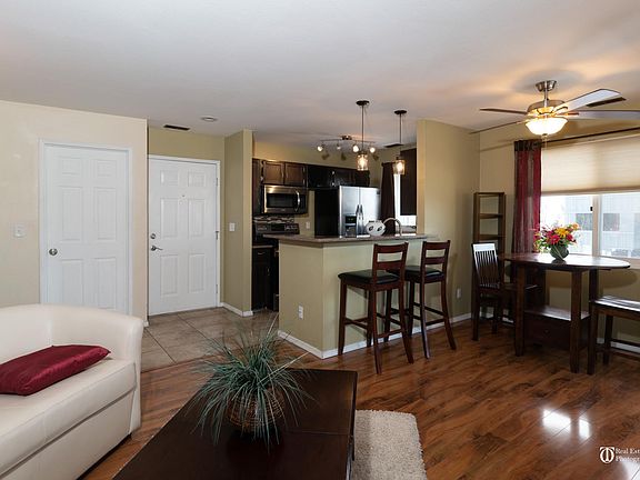 Door on left is closet/pantry, door on right is door to the unit. All windows have Levolor blinds and curtains.