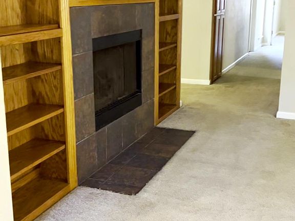 Standing from same vantage point of last (The Kitchen photo) the Familyroom fireplace and hall leading to bath and 3 bedrooms, (1 at the end ,2 to the right and bath on the left)