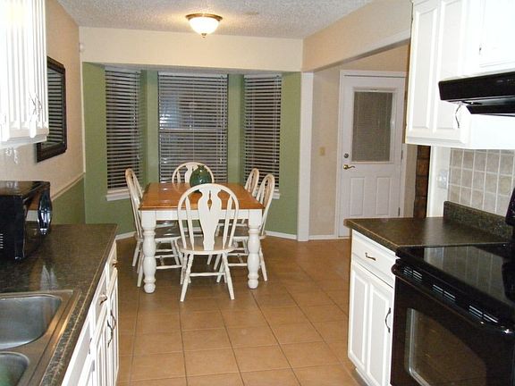 Eat-in kitchen with bay window.