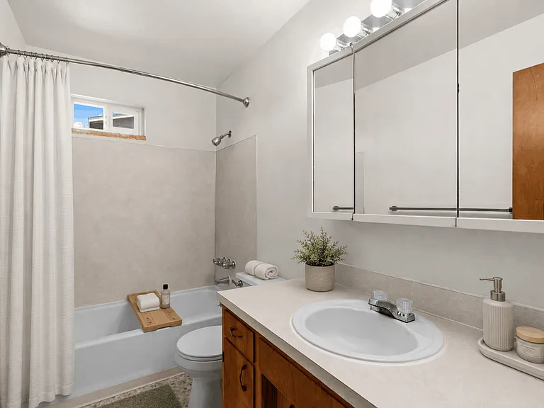 Inviting full bathroom in a one-bedroom deluxe apartment at Palisades Apartments in Tacoma.