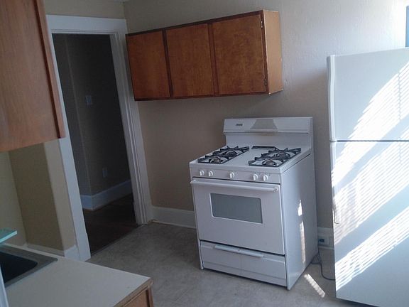 Kitchen featuring a refrigerator and gas stove.