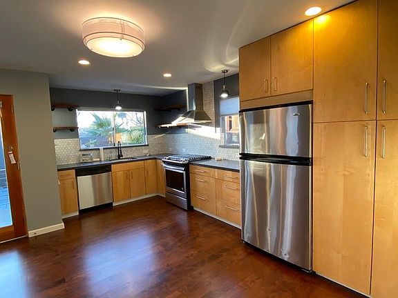 New floors, new backsplash, new appliances, new countertops, and new LED light fixtures and pendants