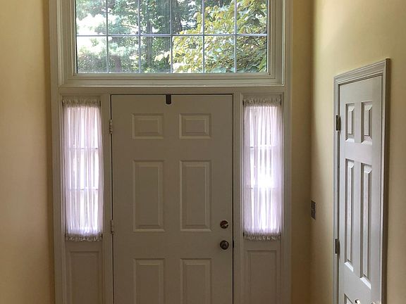 Foyer with cathedral ceiling and powder room