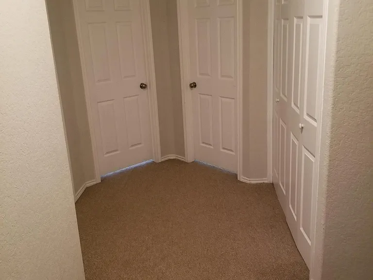 Upstairs hallway towards two bedrooms and laundry closet