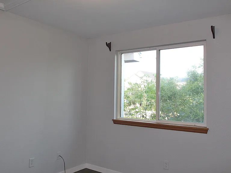Bedroom #2 measures 11' by 10'measures 10'2" by 10'11" and also overlooks the backyard