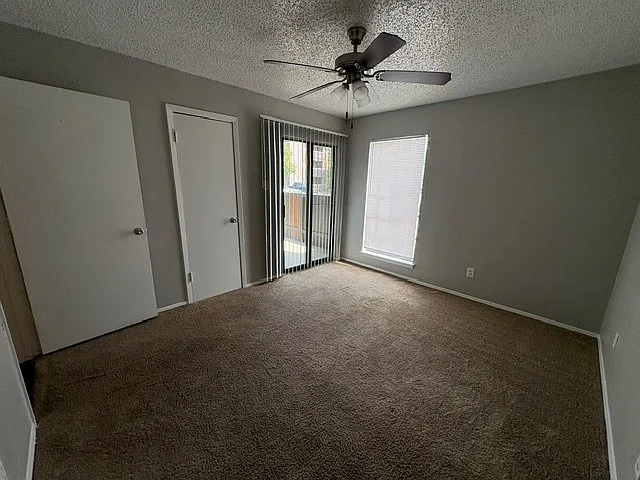 Guest bedroom with walk in closet and access to patio