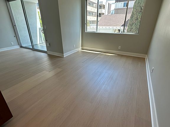 Large Dining Room With Custom Blinds On Window and Slider to Balcony
