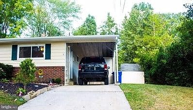 Covered carport to protect from inclement weather with side door entrance to kitchen
