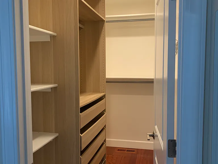 Spacious walk-in closet with shelves, drawers, and hanging space to keep your clothes organized.