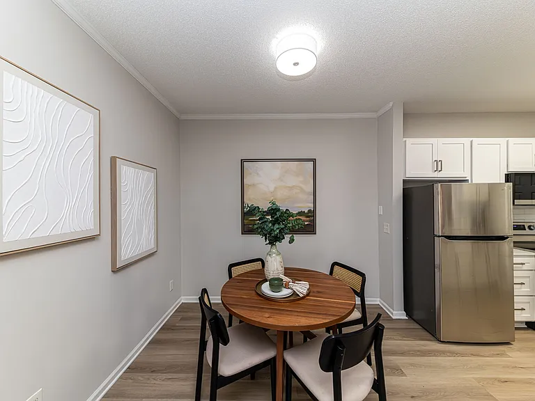 Dining area with hardwood-style flooring and overhead lighting