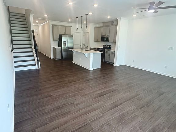 Open first floor concept, matte black ceiling fans with remote, upgraded enhanced vinyl plank flooring