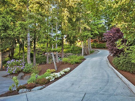 The front of the house, with views of the mountains and wraparound deck. The large, flat driveway allows for plenty of parking with ease.