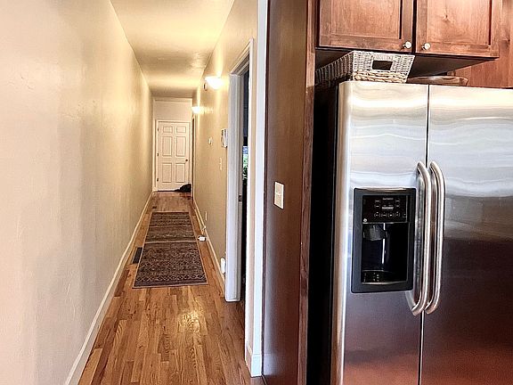 Hallway to 2 bedrooms, laundry room, 3/4 bath, and to garden level