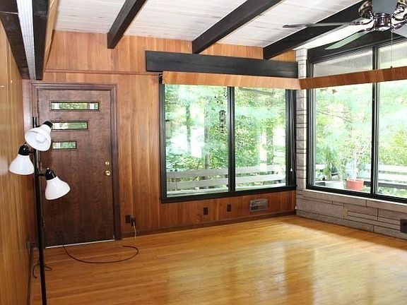 Living Room with side door to front wrap-around deck