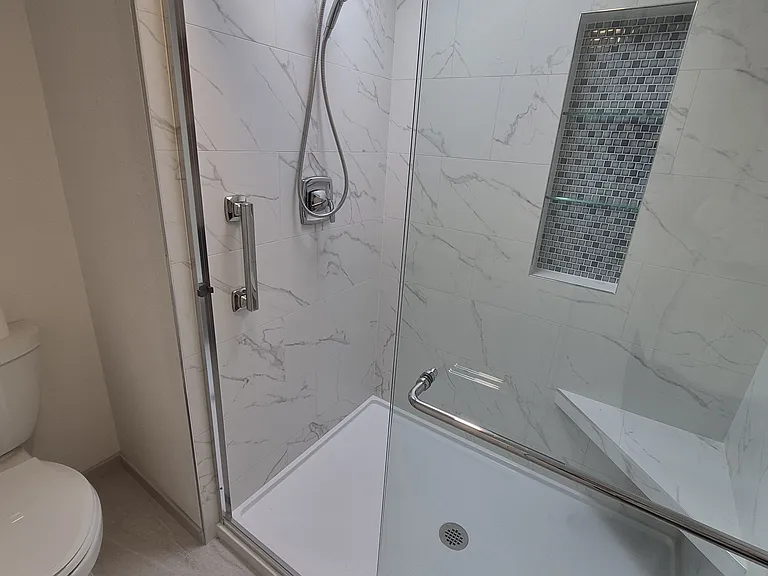 Walk-in shower with hand rail for safety. Seat for ease of comfort. Skylight and all new fixures.