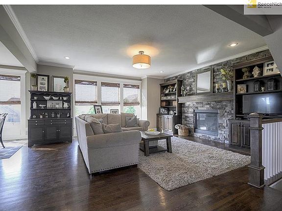 This large open Great Room is where all the action happens. Upgraded wall of stone and built-ins on each side of the gas fireplace allows plenty of room to store those books, games and videos. What family wouldn't feel the love in this room. Notice the wa