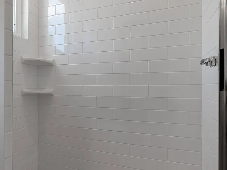Large, tiled shower in main bedroom.