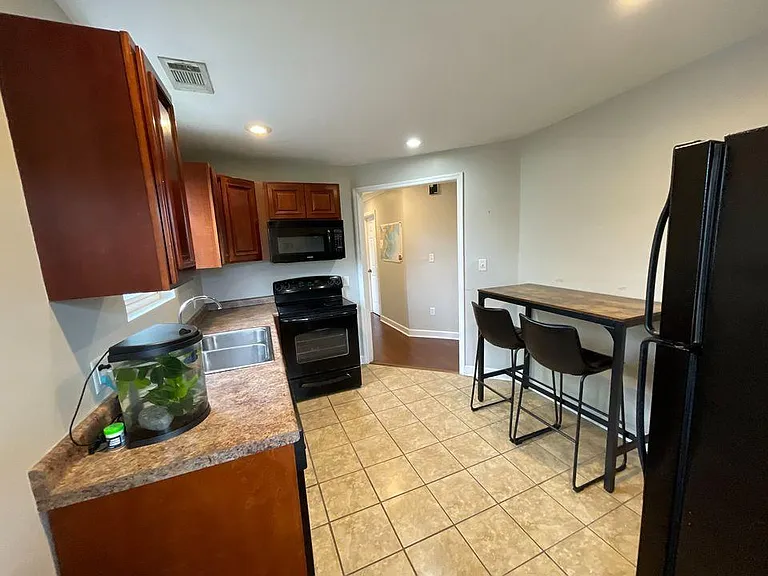 Open kitchen layout with tile floors, plenty of counter space, and a dedicated dining area.